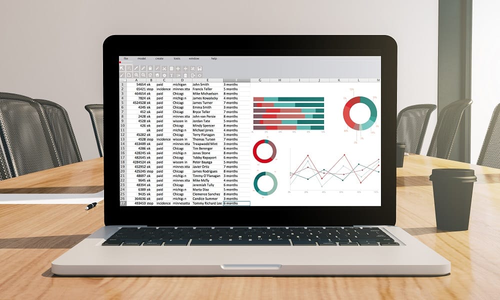 A laptop with a spreadsheet on the screen, on a conference room desk. This article tells why businesses should use Google Sheets